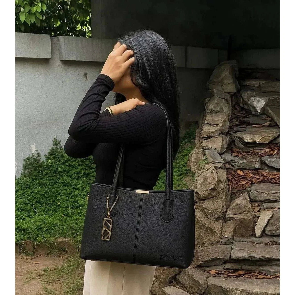  Model holding Everyday Elegance Black shoulder bag by Zaiduxe